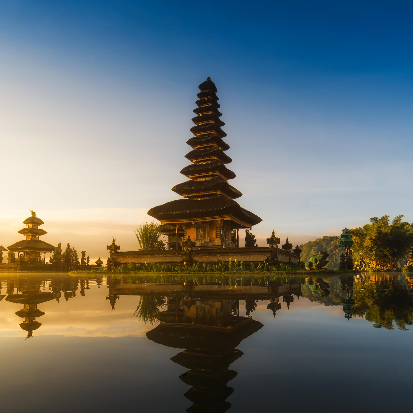 Serene sunrise at the Pura Ulun Danu Bratan Temple in Bali, Indonesia, with its reflection on the lake.