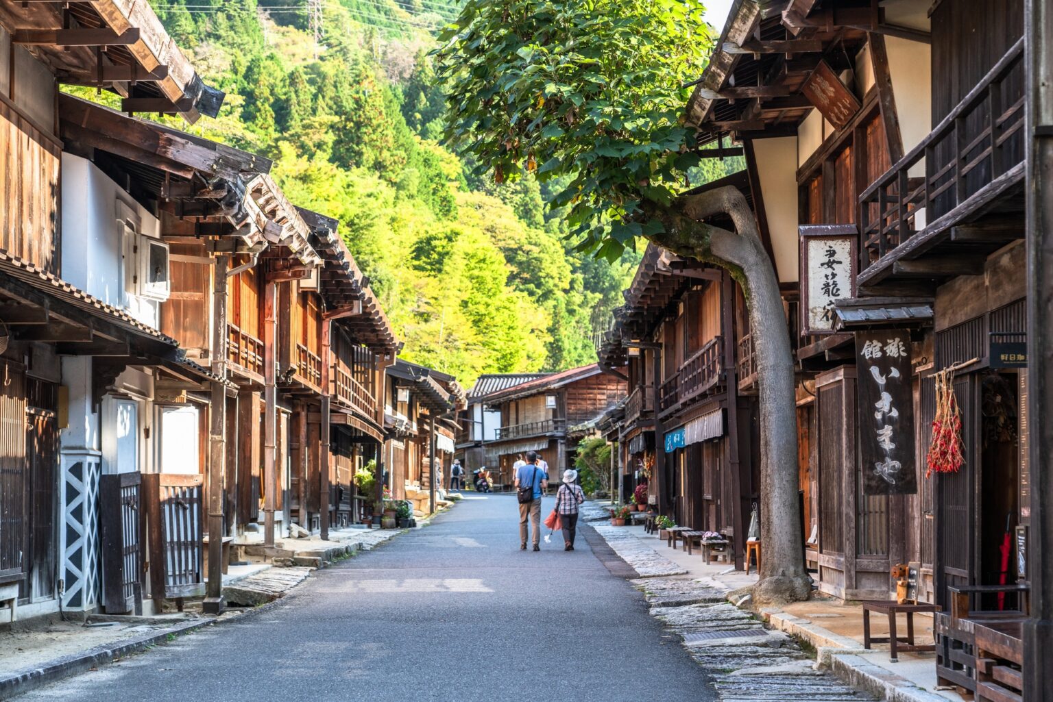 Traditional wooden buildings in Tsumago village and Matsumoto Castle known as The Crow during Japan tour from Dubai